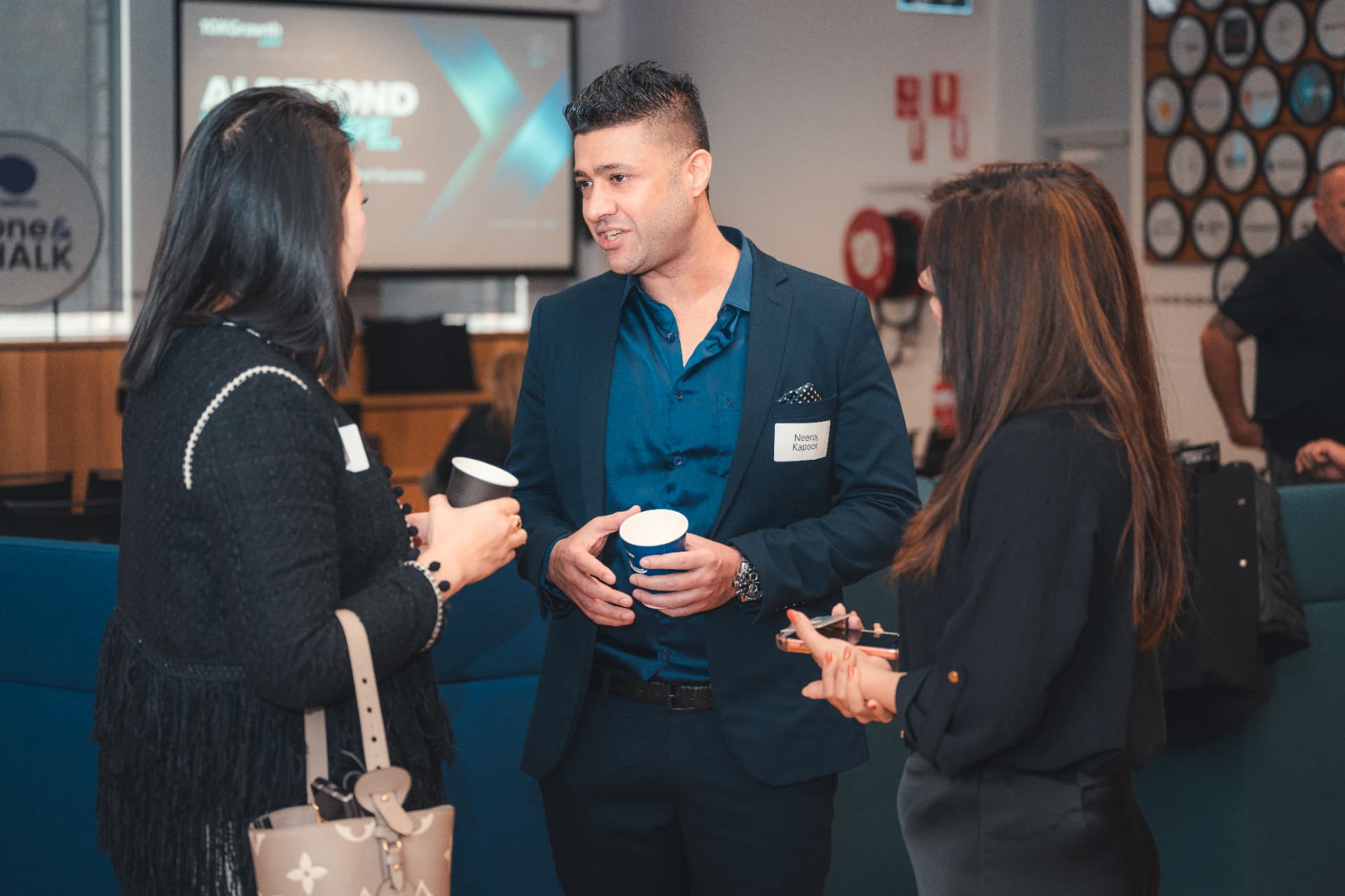 Neeraj Kapoor talking with attendees at a 10xGrowth Labs AI event